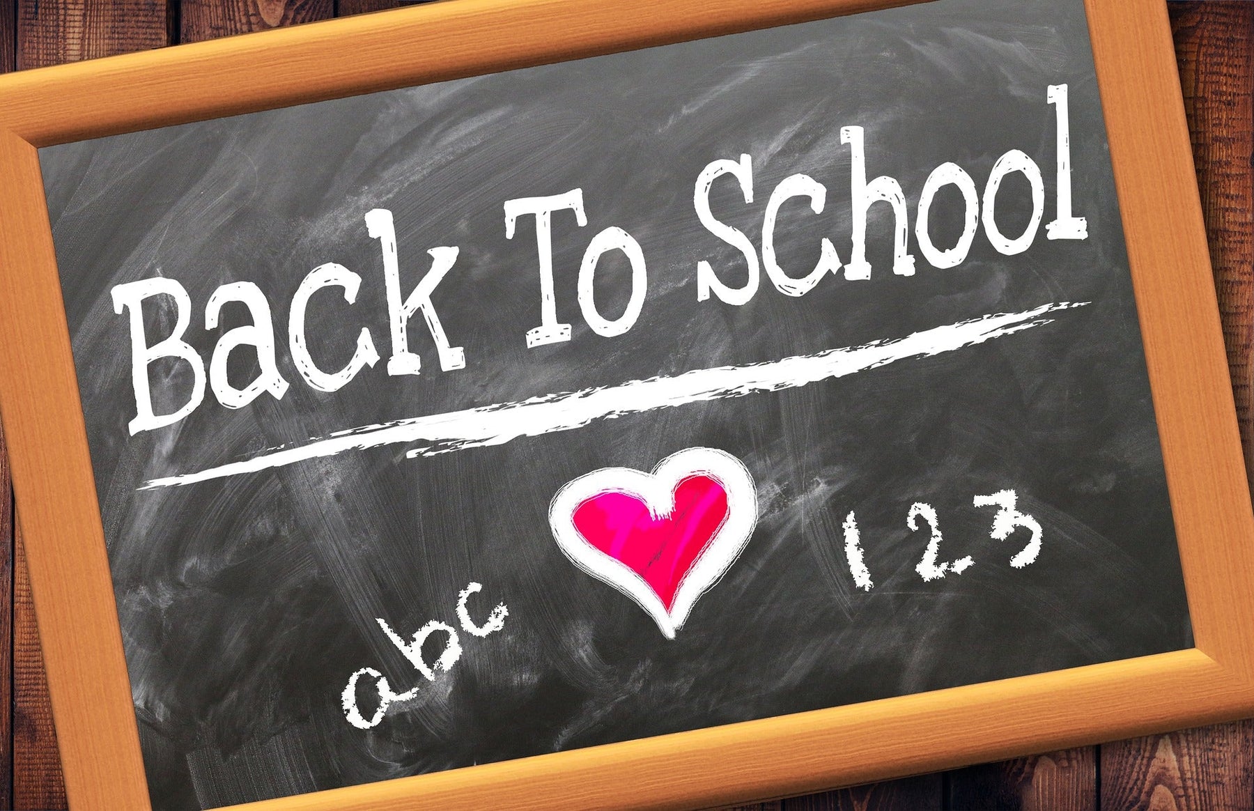 Black board reading back to school with a red heart in the middle
