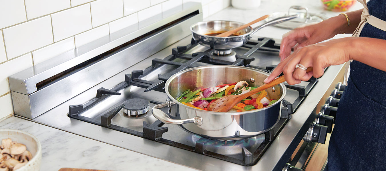 Woman cooking on an inox stove