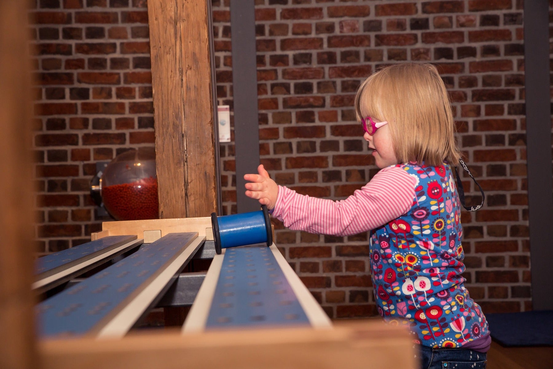 Blonde kid playing with blue toy
