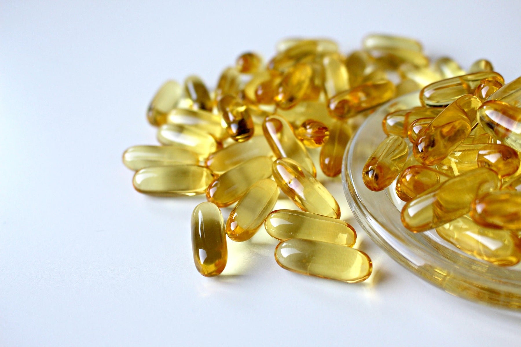 Fish oil pills over a small glass plate