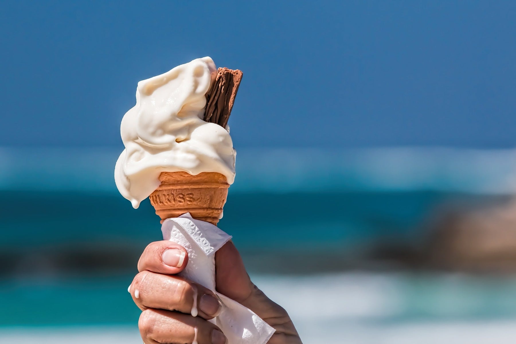 Eating ice cream with a piece of chocolate next to the beach