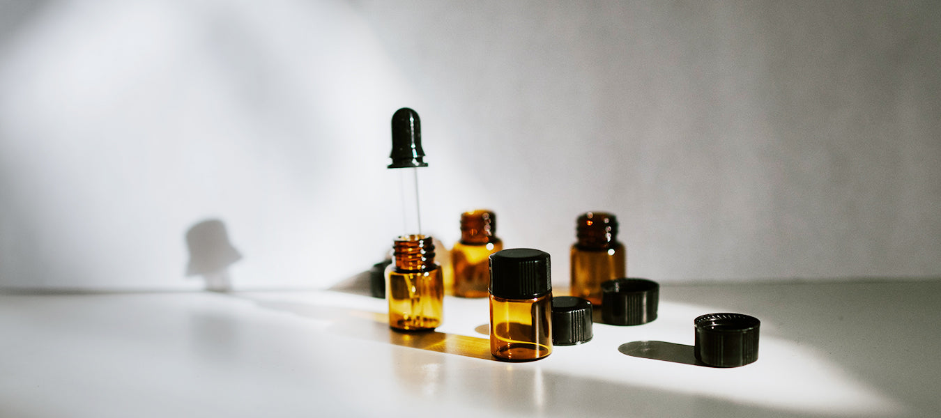 Small bottles with and without the cap sitting on a table