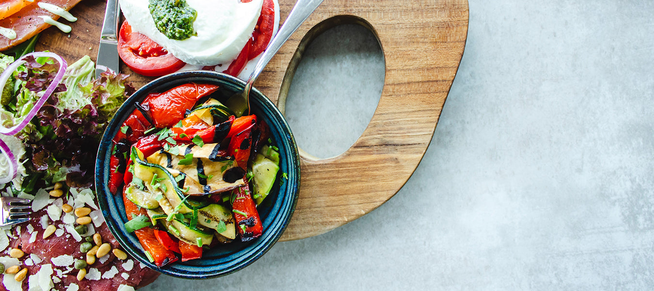 Mix of vegetable in bowls sitting on a chopper