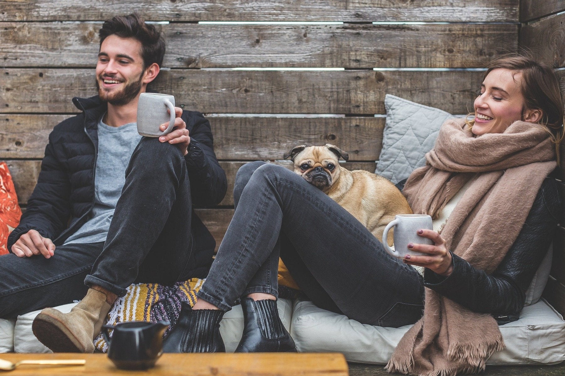 Man and woman outside with their dog sitting on the floor