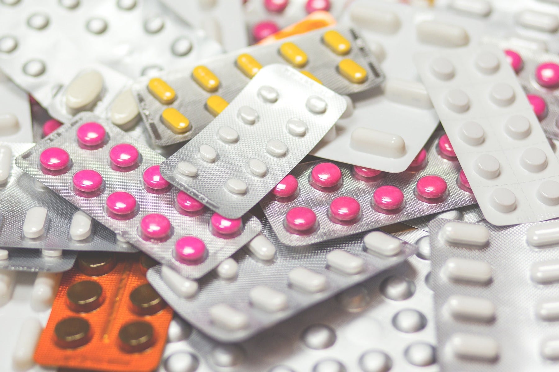 Many pills laying next to each other unopened