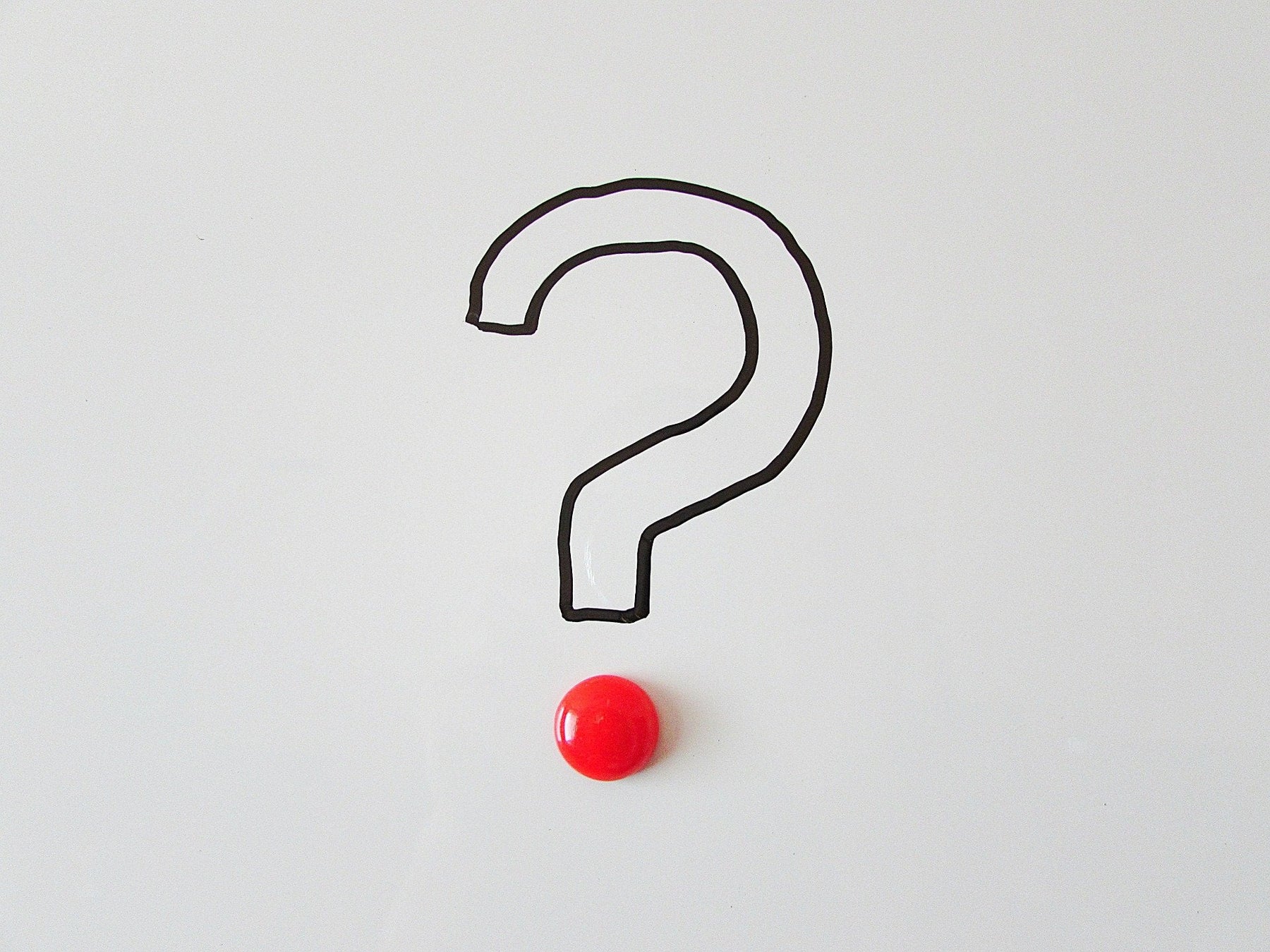 Question mark on a grey background with a red dot