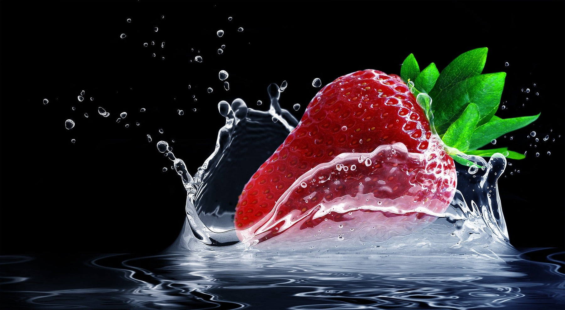 Strawberry dropping in water creating a splash