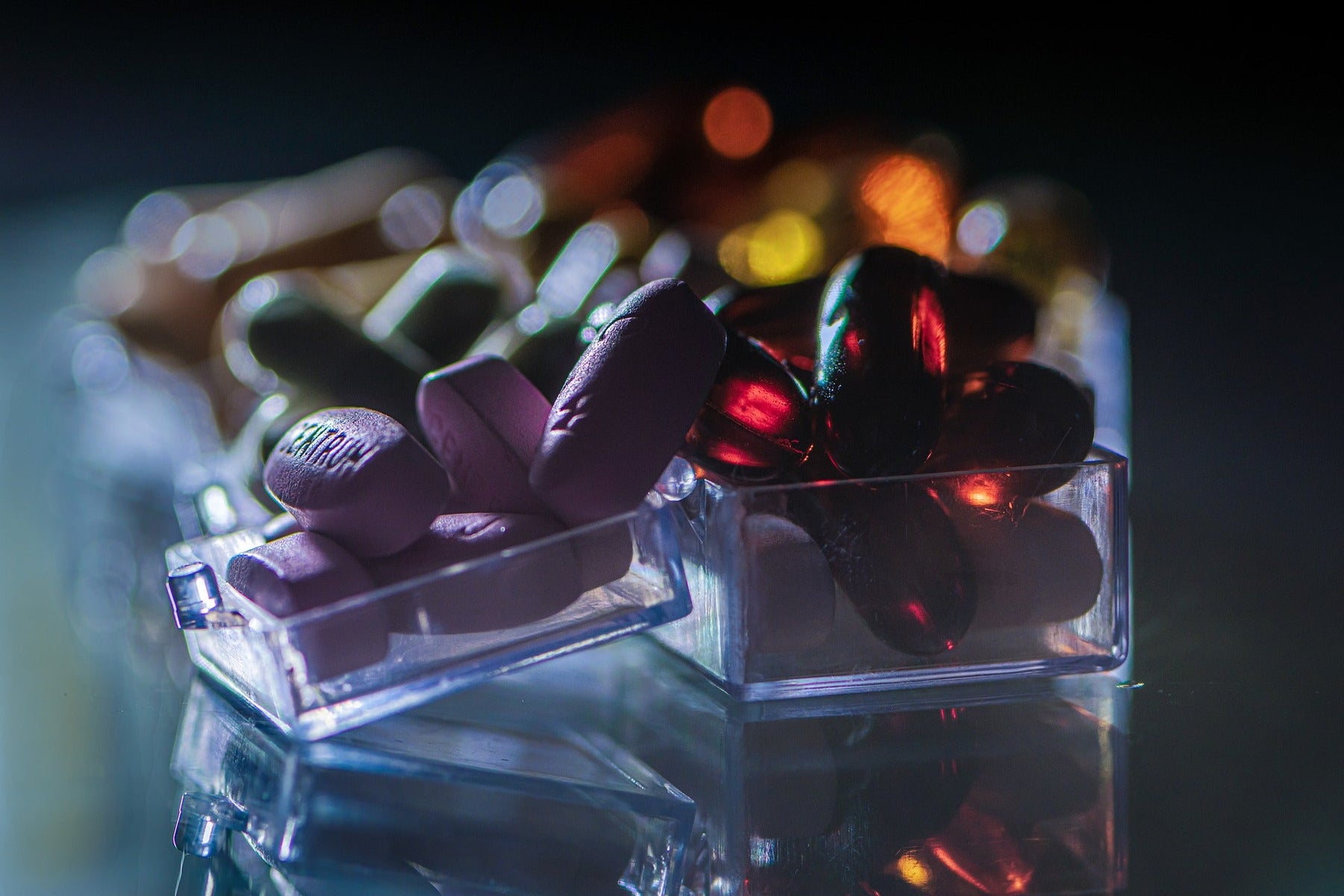 Different pills in a few glass recipients