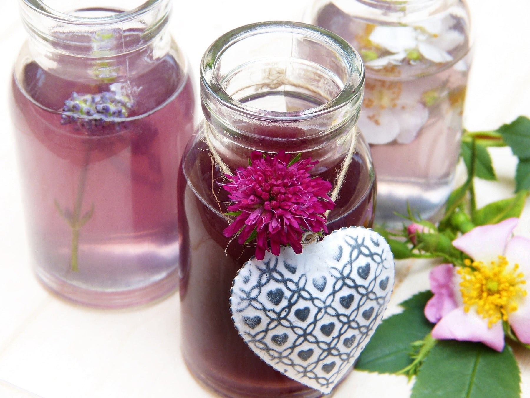 Jars with red liquid and a hanging metal heart