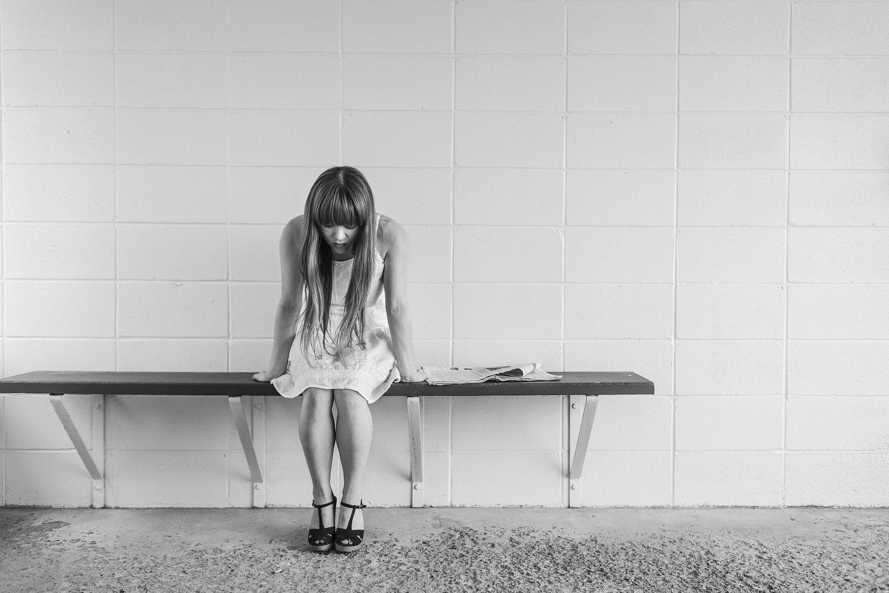 Worried woman sitting on a bench