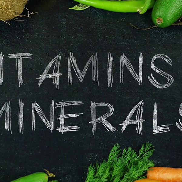 Clark board surrounded by greens reading Vitamins and Minerals