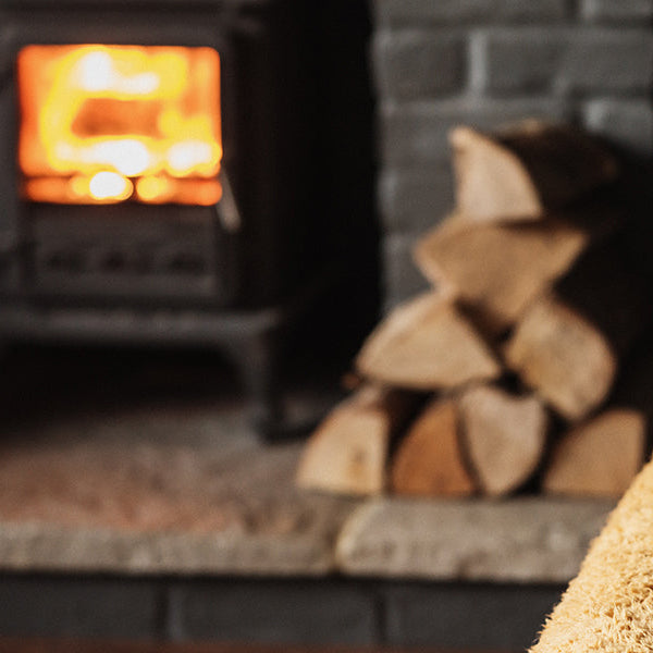 Wood laying next to a fireplace