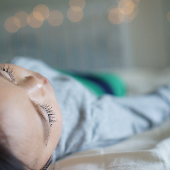 Brunette woman dressed in white sleeping