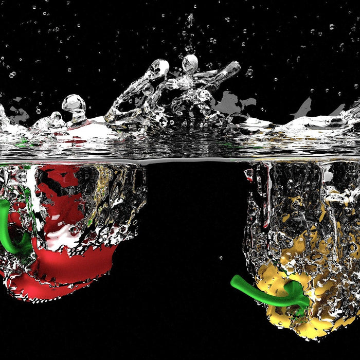Red bell pepper and yellow bell pepper dropped into water
