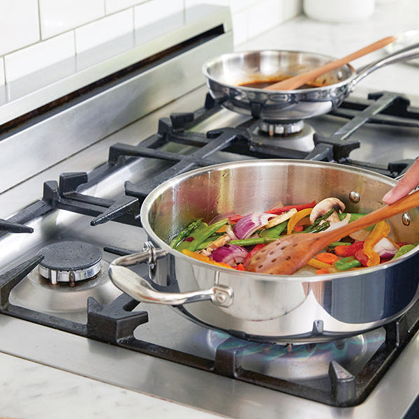 Woman cooking on an inox stove