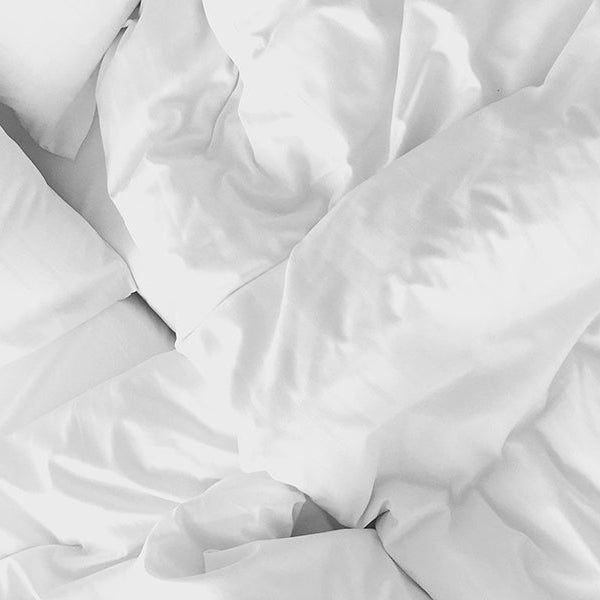 White quilt over white bed