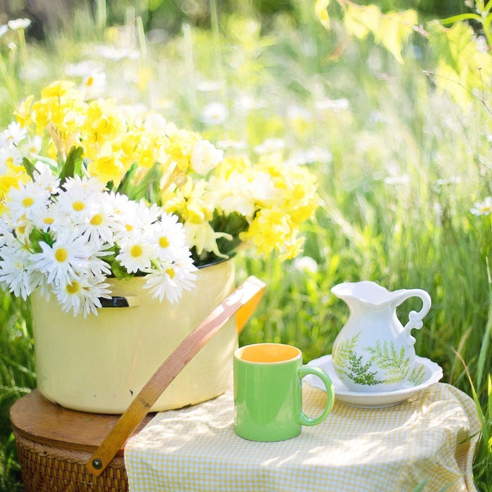 Tea outside in nature surrounded by flowers