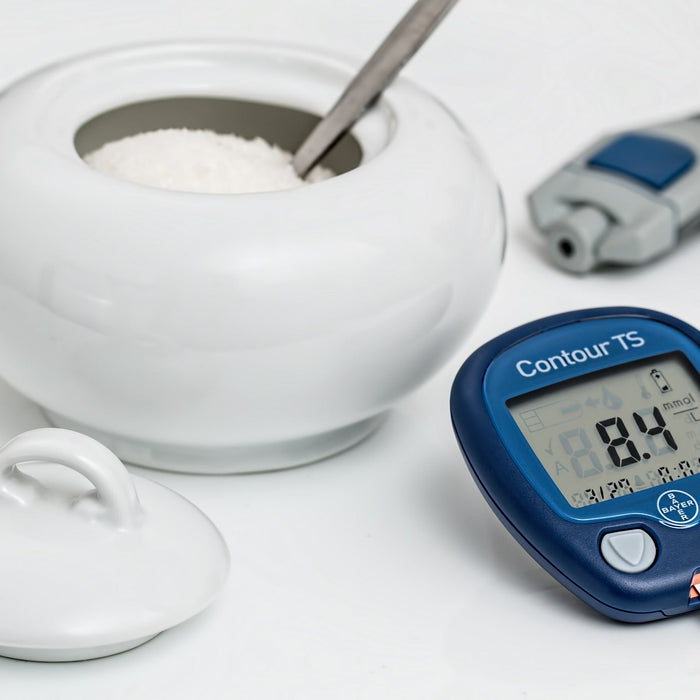 A digital measurement next to a white bowl of sugar