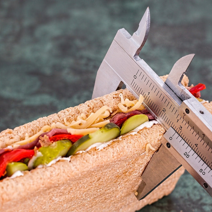 Sandwich being measured with a fat percentage device