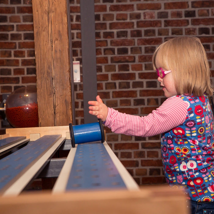 Blonde kid playing with blue toy