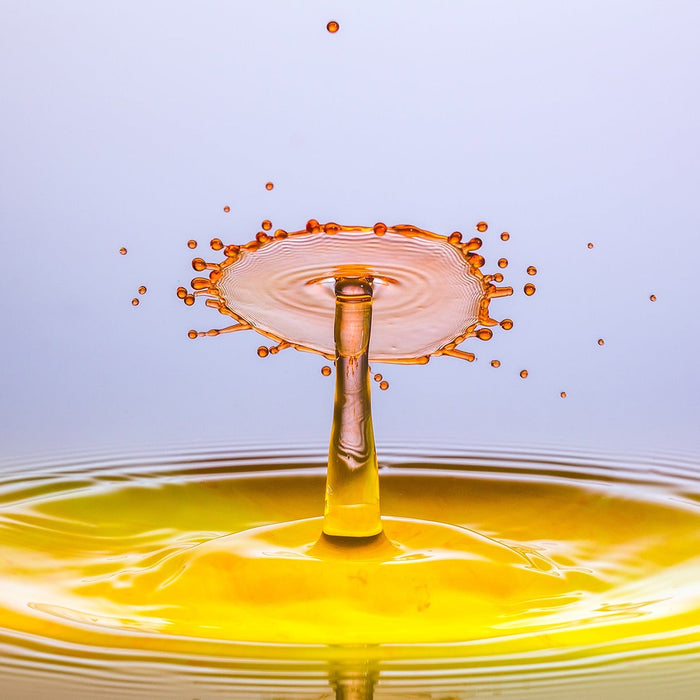 Liquid dropping creating a yellow splash