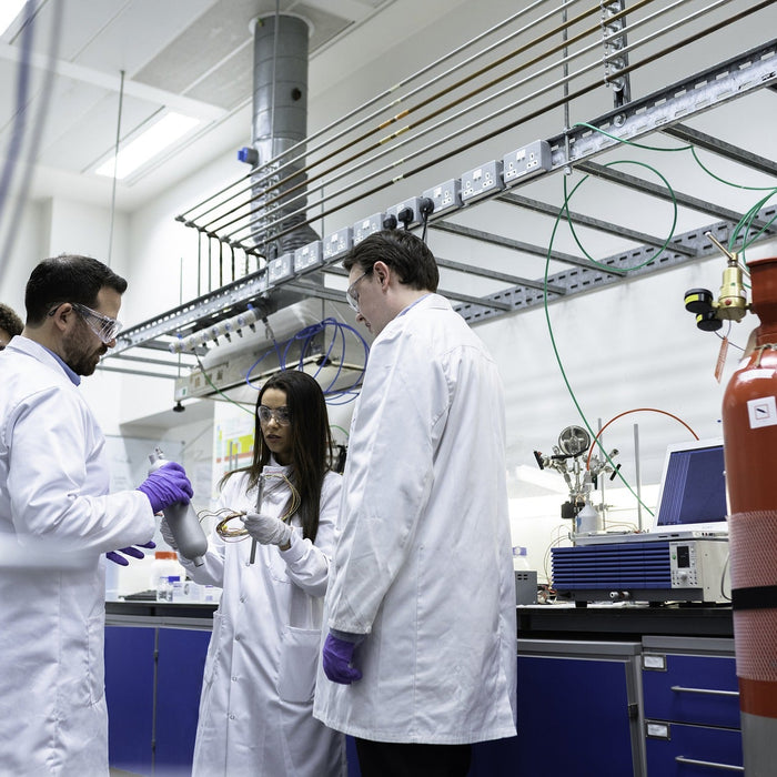 People dressed in white in a laboratory