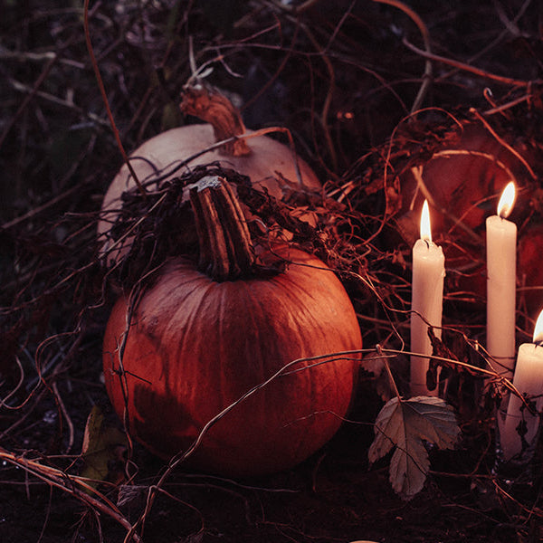 Dark place with a pumpkin and candles nearby
