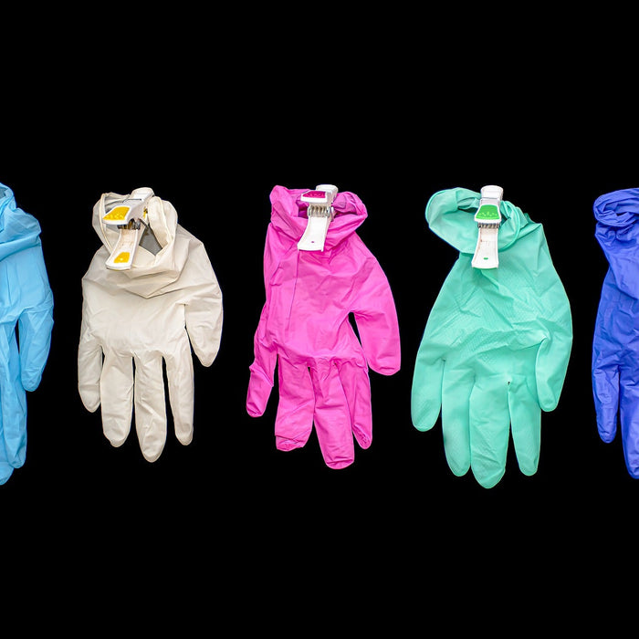 Five surgical gloves of different colors