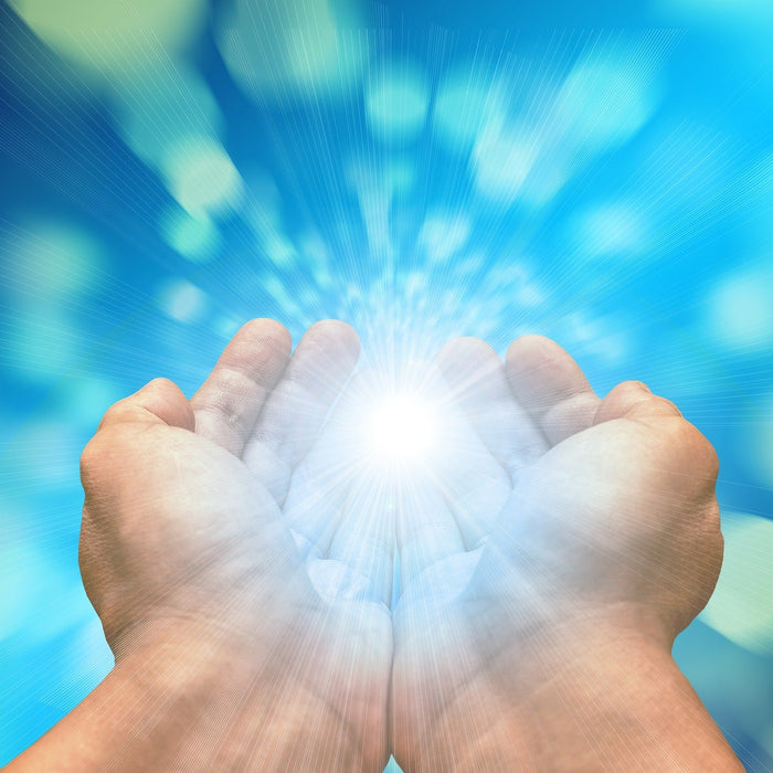 Two hands holding light in hands