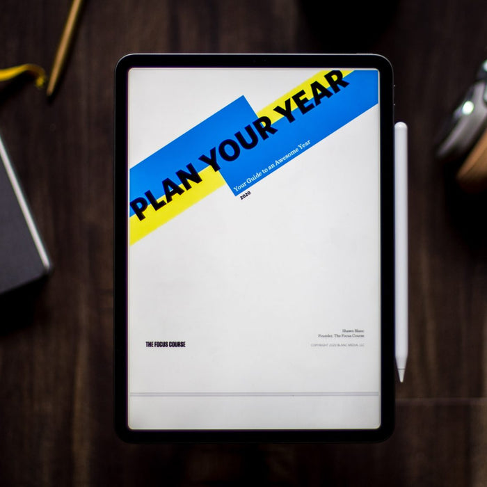 Desk with agenda, notebook and headphones