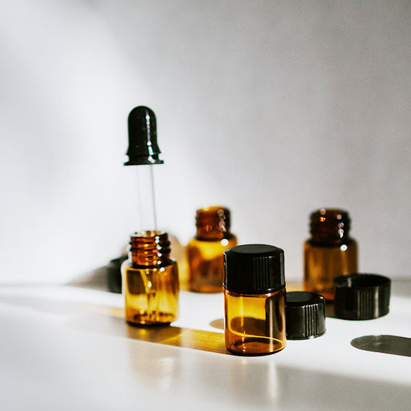 Small bottles with and without the cap sitting on a table