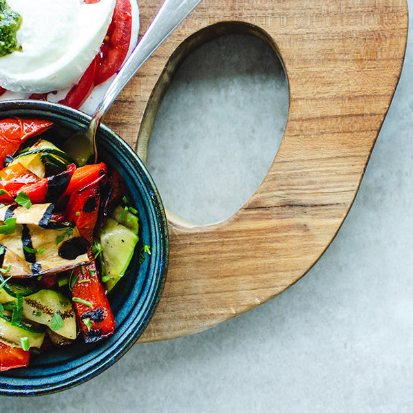 Mix of vegetable in bowls sitting on a chopper