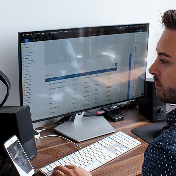 Man working with two monitors and one phone at the same time