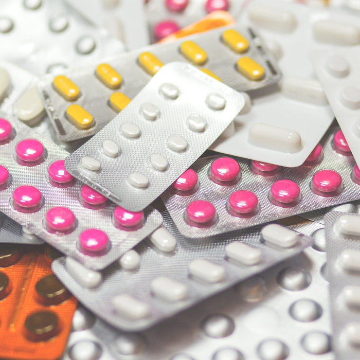 Many pills laying next to each other unopened