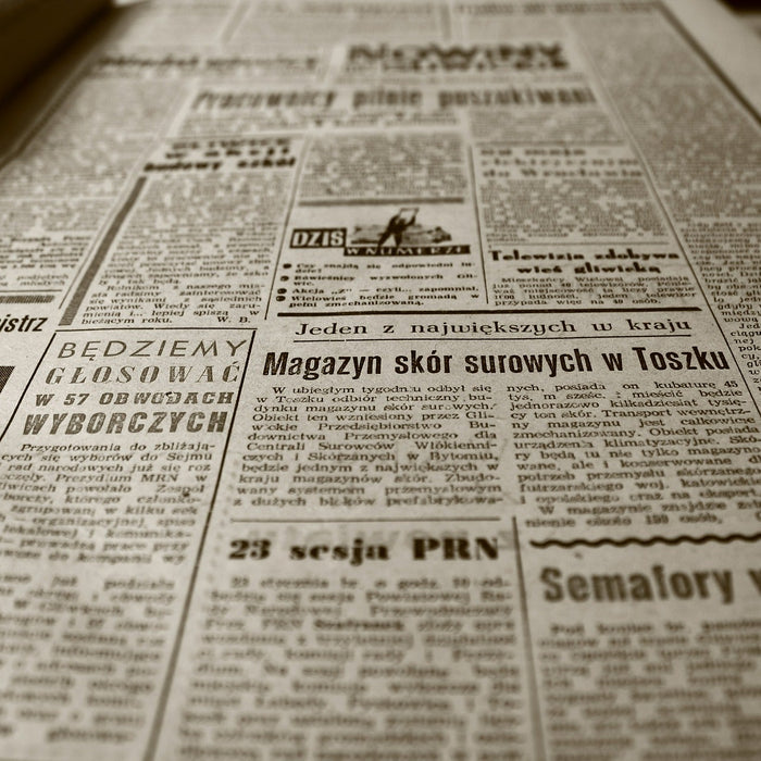 Large old newspaper laying on a table