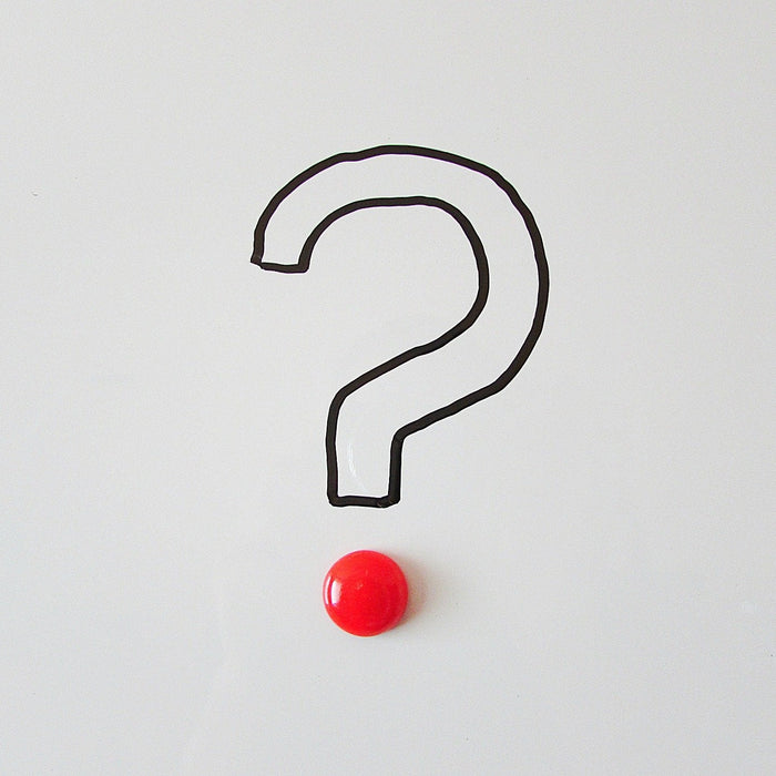 Question mark on a grey background with a red dot