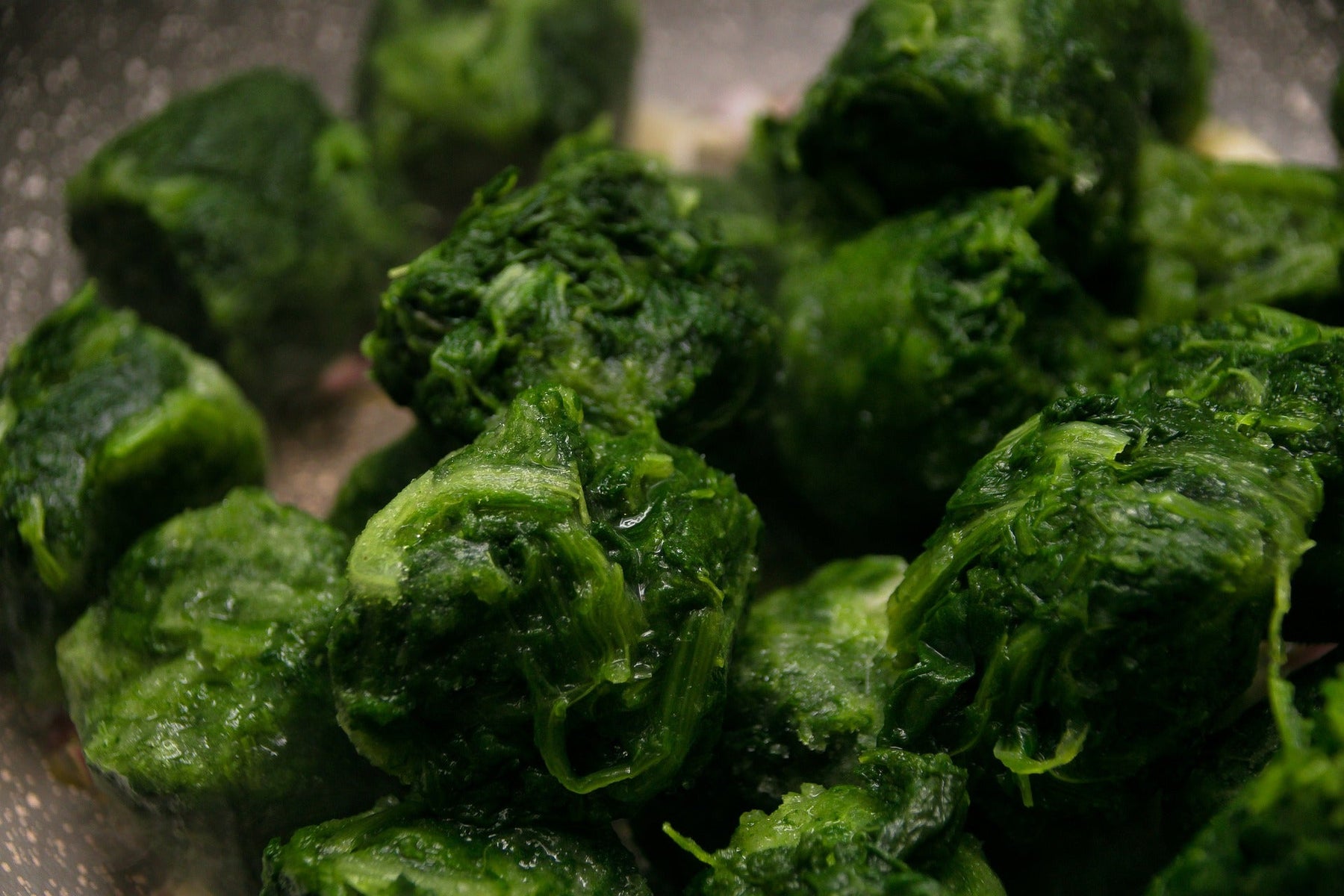 Pressed spinach in cubes laying in a pan