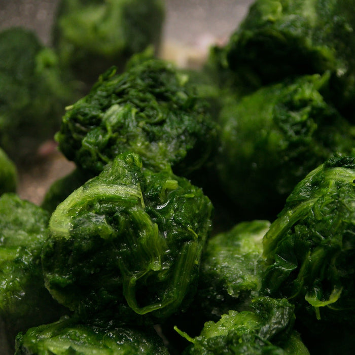Pressed spinach in cubes laying in a pan