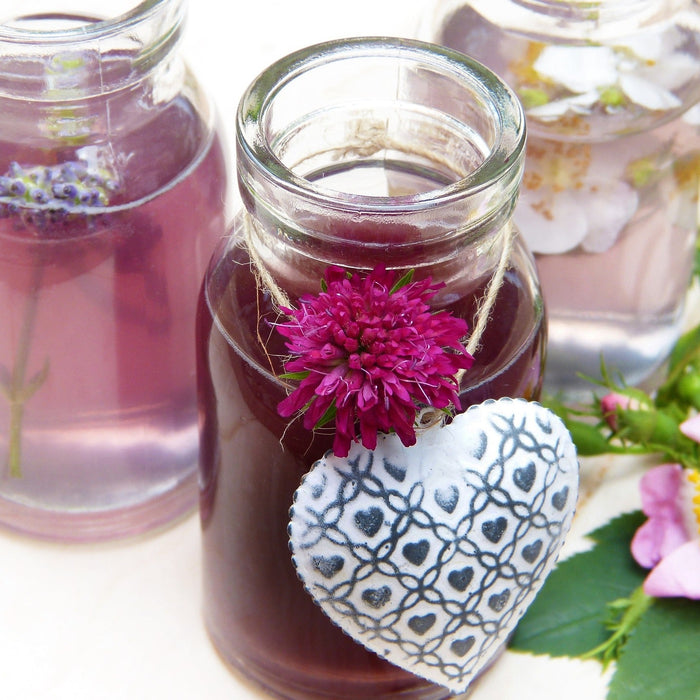 Jars with red liquid and a hanging metal heart