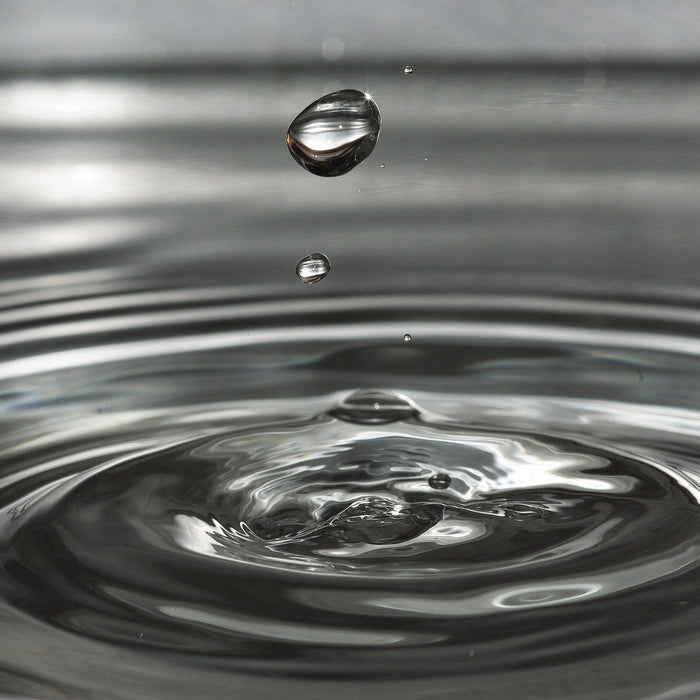 Splash creating a drop of water in the air