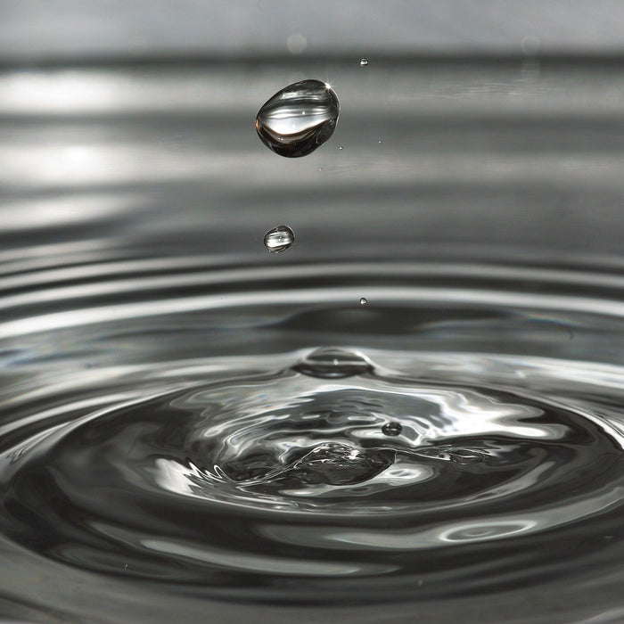 Drop of water creating waves around it