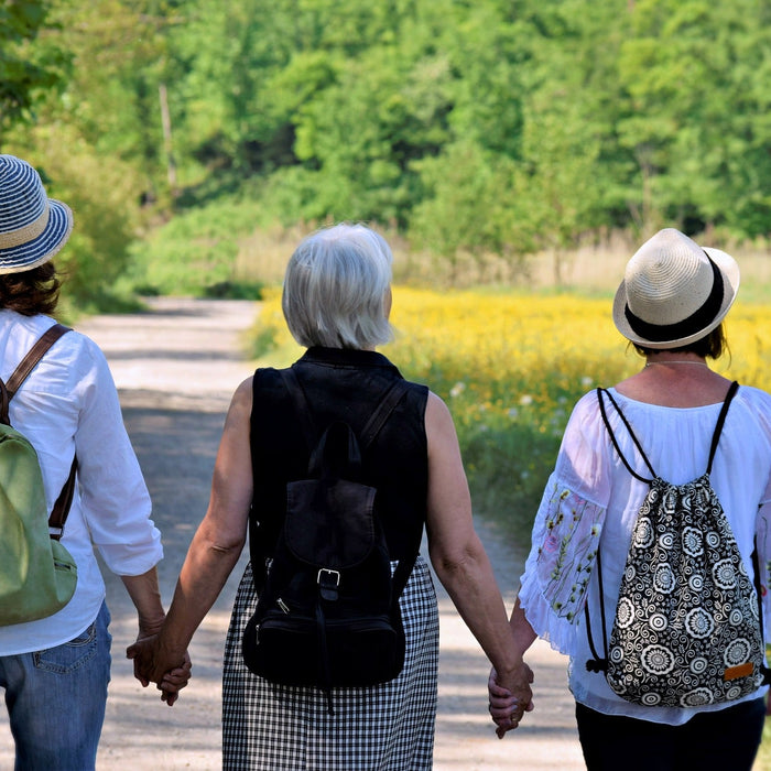 Three women walking and holding hands