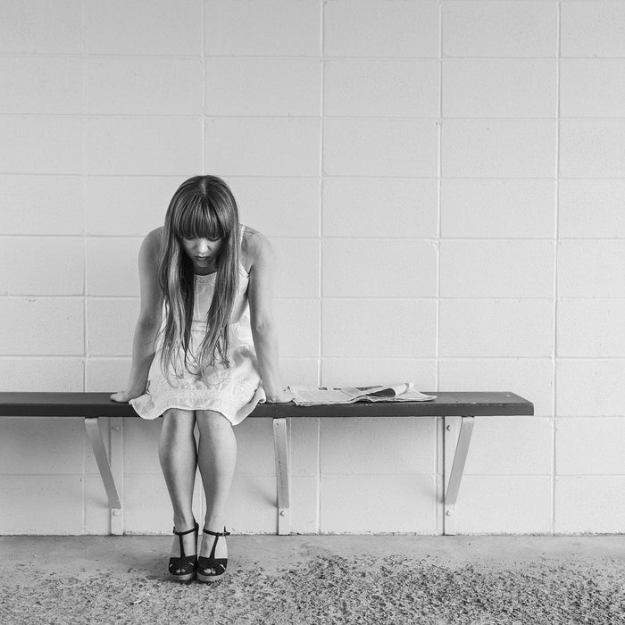 Worried woman sitting on a bench